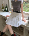 A classic pleated skirt featuring a high waist and knee-length design