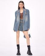 A distressed denim blazer featuring a charming butterfly pin and frayed edges. This jacket includes large front pockets and a lapel collar, perfect for adding a vintage and grunge touch to any outfit