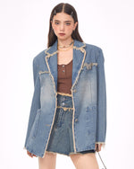 A distressed denim blazer featuring a charming butterfly pin and frayed edges. This jacket includes large front pockets and a lapel collar, perfect for adding a vintage and grunge touch to any outfit