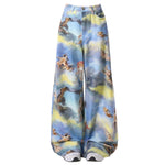 These blue wide-leg pants featuring a dreamy sky print with angelic cats, styled as cherubs - boogzel clothing