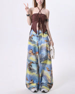 These blue wide-leg pants featuring a dreamy sky print with angelic cats, styled as cherubs - boogzel clothing