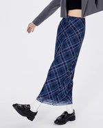 A stylish blue plaid maxi skirt with a high-waist design and drawstring closure. The skirt features a checkered pattern in varying shades of blue, creating a modern yet classic look. Its long, straight silhouette provides a sleek and elegant appearance, perfect for both casual and semi-formal occasions