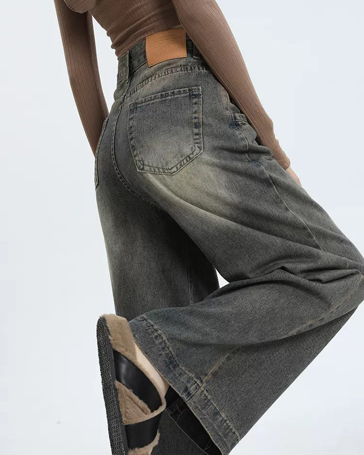 Wide-leg jeans in a faded black wash, featuring a relaxed fit and distressed detailing. Perfect for a casual, grunge-inspired style