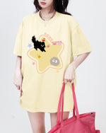 Casual oversized yellow t-shirt featuring a playful cartoon black cat and star print - Boogzel Clothing