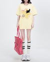 Casual oversized yellow t-shirt featuring a playful cartoon black cat and star print - Boogzel Clothing