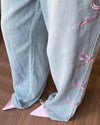 Wide-leg, soft blue jeans with pink coquette bow embroidery along the sides - boogzel clothing