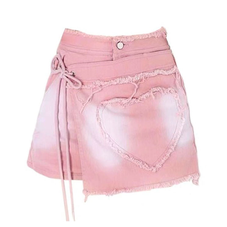 Pink denim wrap skirt featuring a heart-shaped lace appliqué, complete with a tie waist and frayed hem - Boogzel Clothing