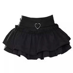 Layered pink ruffle skirt with delicate frills and a cinched waist, highlighted by a heart-shaped charm. Ideal for crafting a soft girl aesthetic outfit