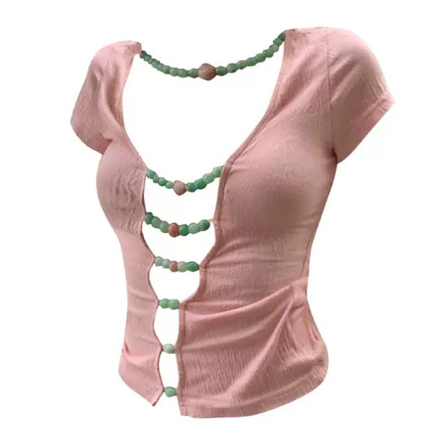 This playful split top features candy-colored beads along the front, adding a touch of whimsy to the soft pink fabric - boogzel clothing