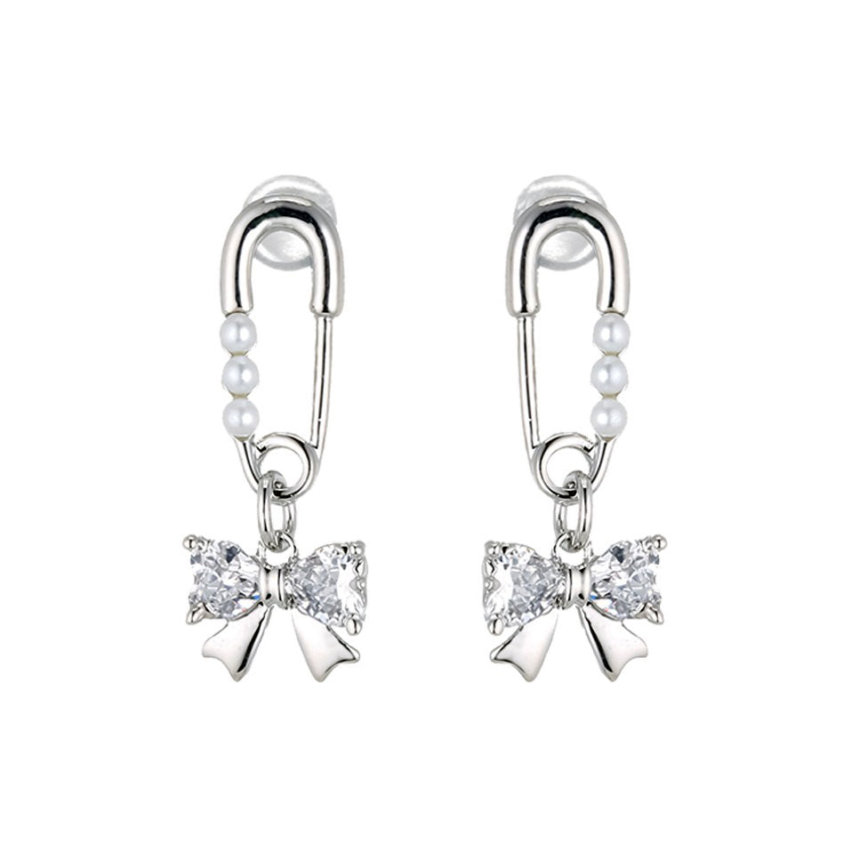 Silver-tone safety pin earrings with three small pearls leading to a sparkling crystal bow