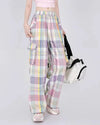 Soft girl aesthetic cargo pants in pastel plaid. Designed with an oversized fit and multiple pockets