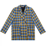 The Oversized Preppy-Style Plaid Blazer features a vibrant blue and yellow plaid pattern. Its double-breasted style and roomy fit make it ideal for layering over any look