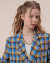 The Oversized Preppy-Style Plaid Blazer features a vibrant blue and yellow plaid pattern. Its double-breasted style and roomy fit make it ideal for layering over any look