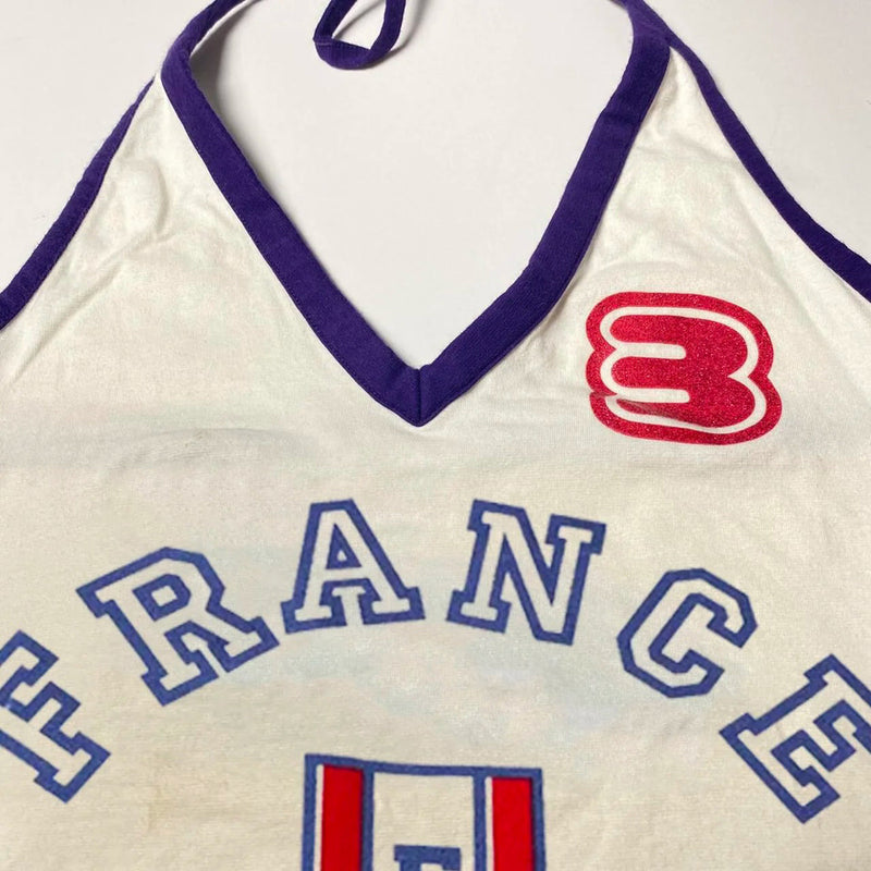 This Nostalgic France Halter Tank brings back 90s fashion with "FRANCE" lettering and a French shield emblem. The halter neck design is perfect for a retro aesthetic look