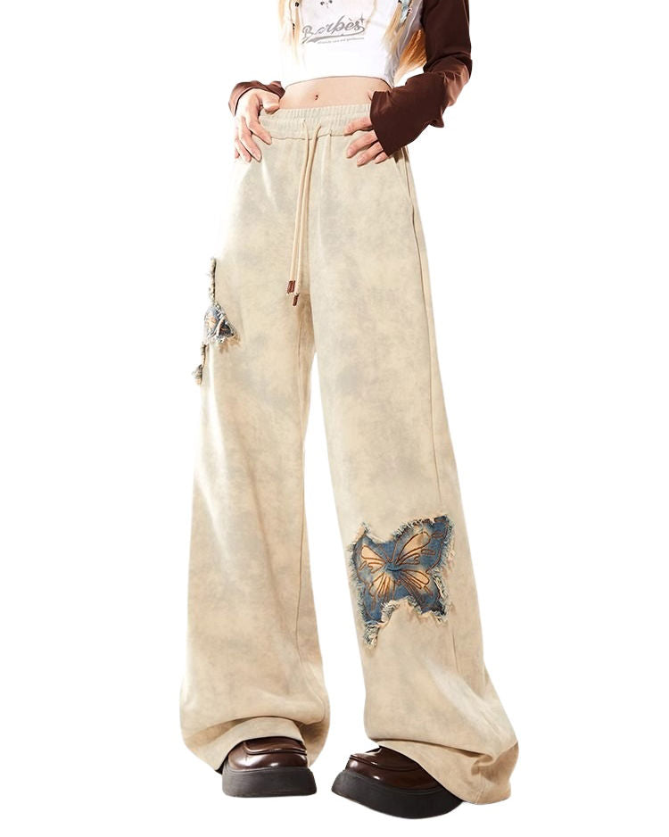 These baggy trousers feature embroidered butterfly patches and a relaxed fit - boogzel clothing