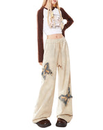 These baggy trousers feature embroidered butterfly patches and a relaxed fit - boogzel clothing