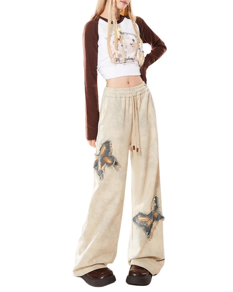 These baggy trousers feature embroidered butterfly patches and a relaxed fit - boogzel clothing