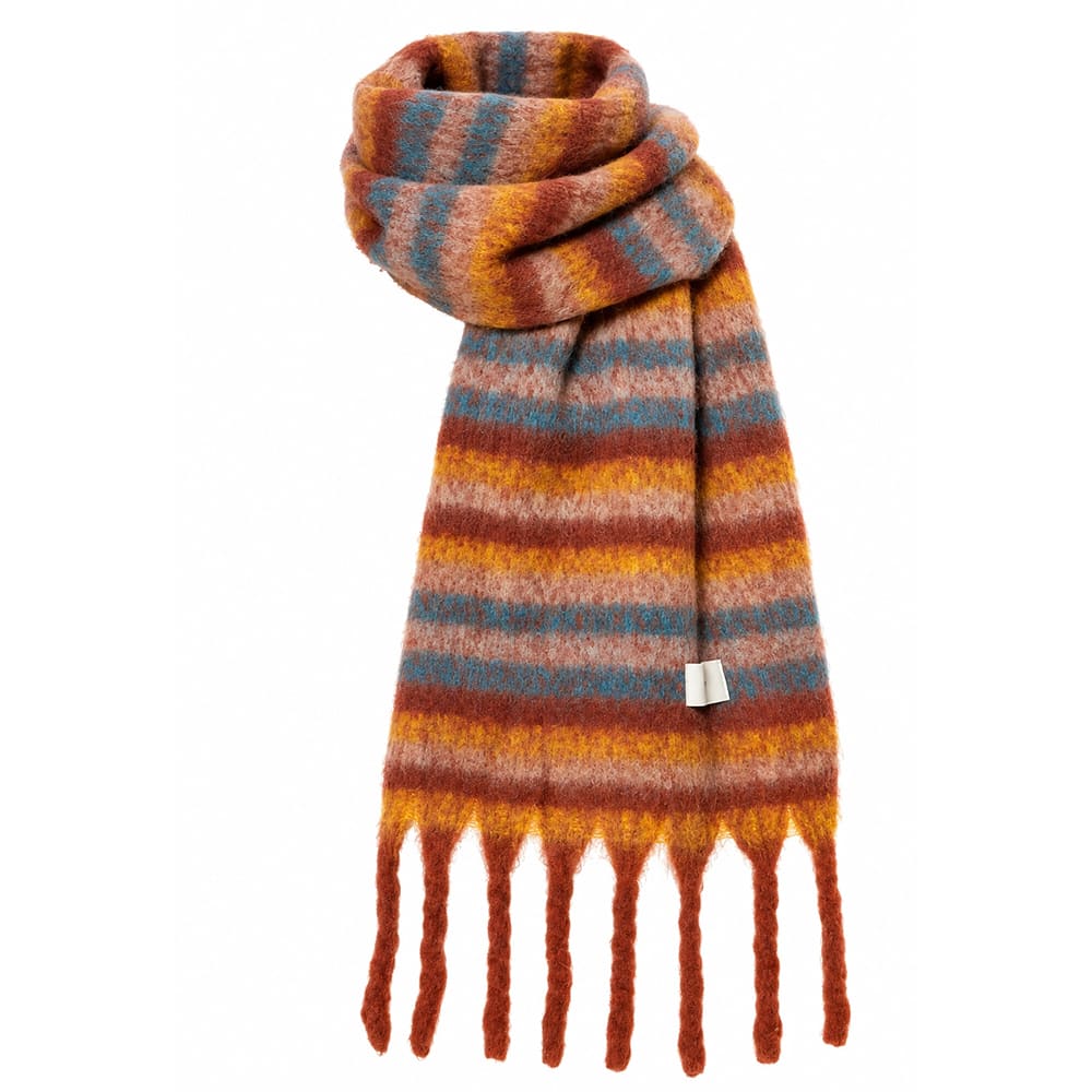 A fuzzy striped knit scarf with fringe ends, featuring horizontal bands of rust red, mustard yellow, orange, and muted blue-gray