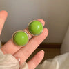 green glossy round stud earrings boogzel clothing