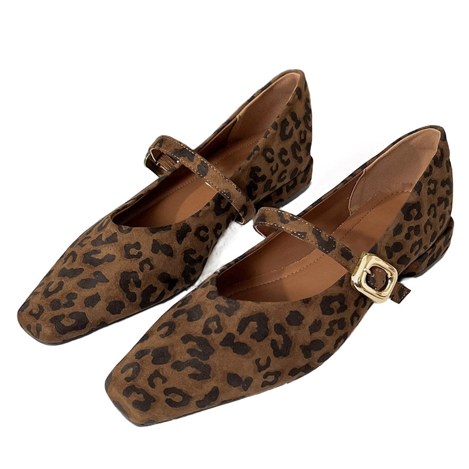 This aesthetic Mary Jane shoe featuring a square toe, low block heel, and soft suede-like surface. Designed with a slim strap and shiny gold buckle