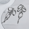 silver bow earrings boogzel clothing
