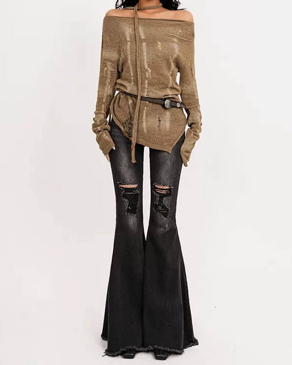 Distressed flare jeans in faded blue denim with ripped knees, frayed hems